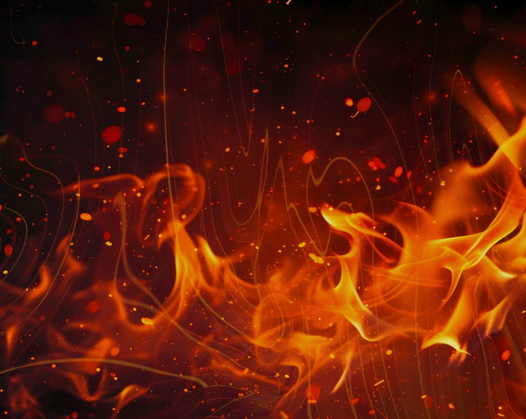 Fotografía con fondo negro y fuego encendido de color naranja y rojo.